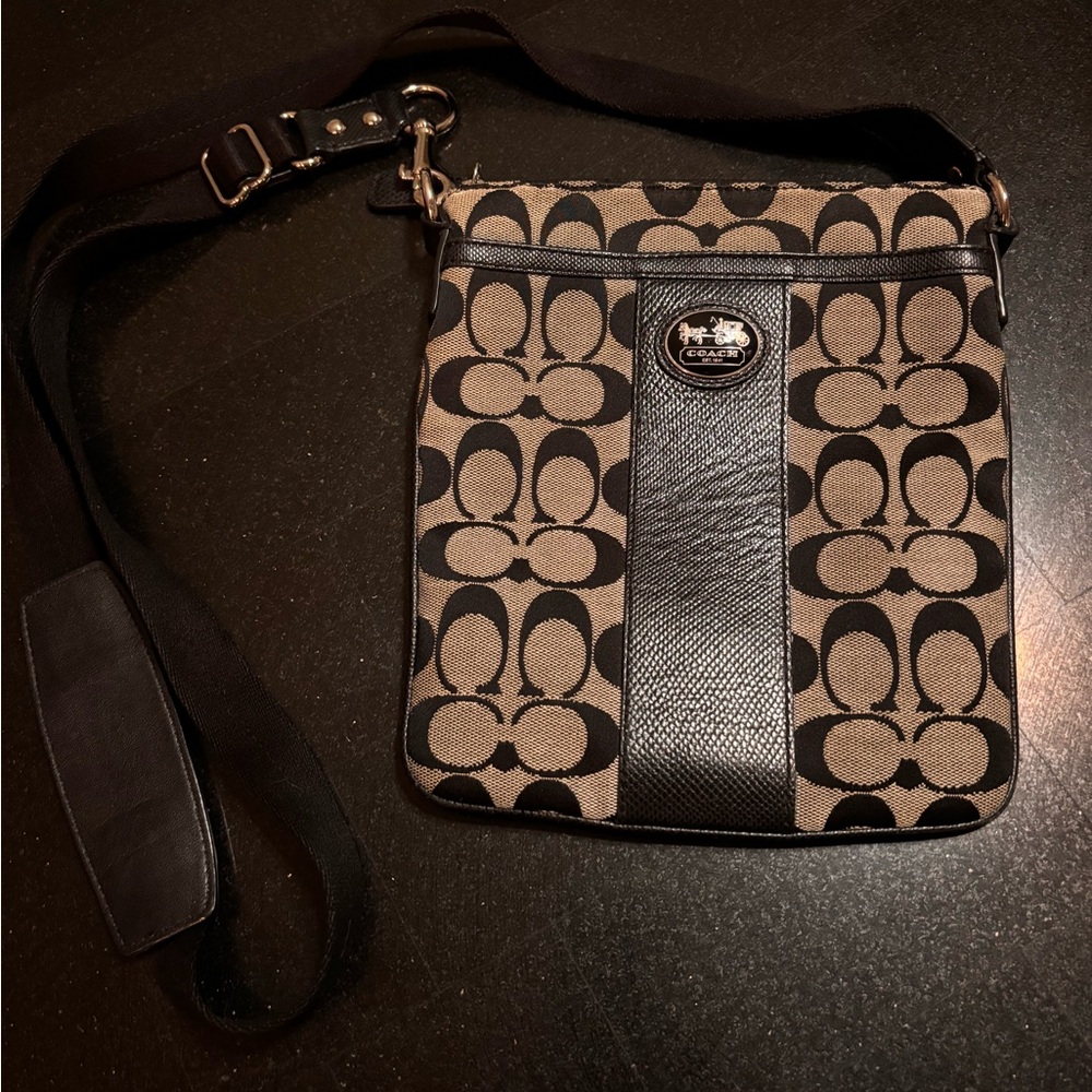 Coach small cross body bag black and tan with light blue lining.